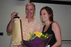 Bernie Degnan presenting Carmel McDougall with flowers and Australian whisky